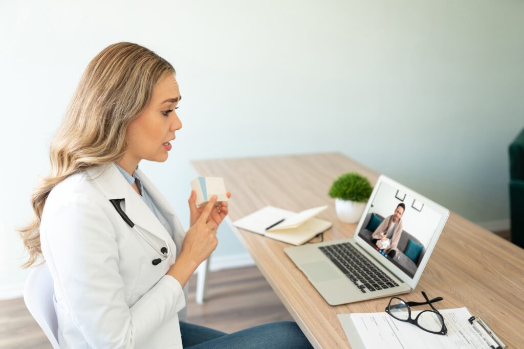 Female doctor prescribing medicine to patient